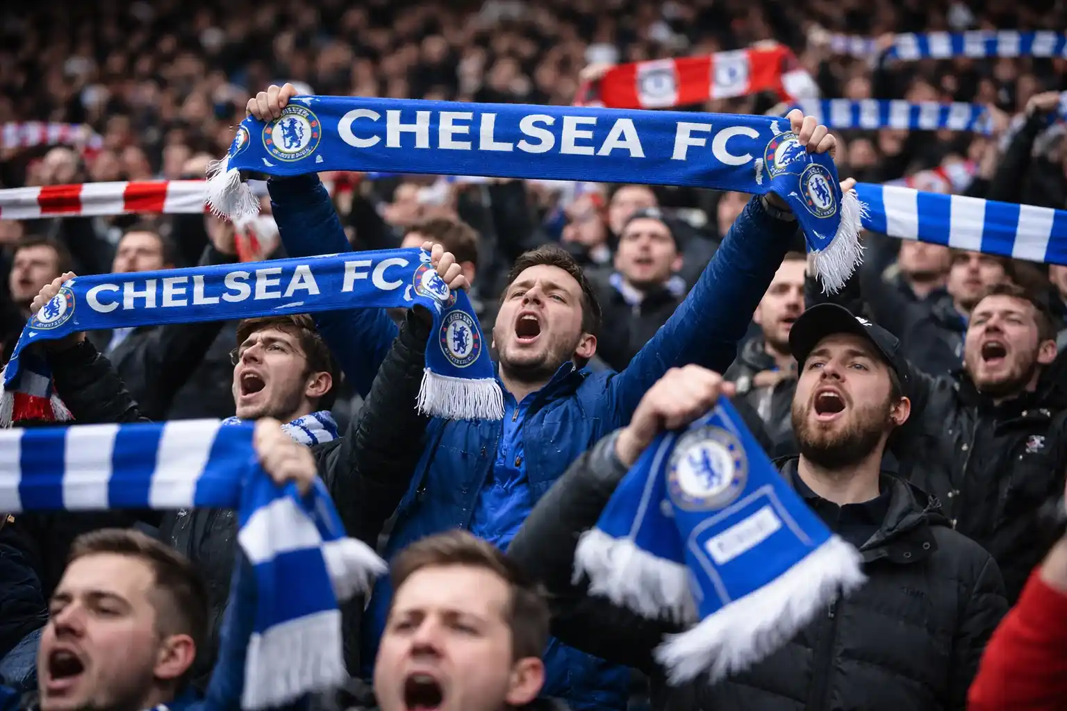 Football supporters holding scarves and flags during a London derby match