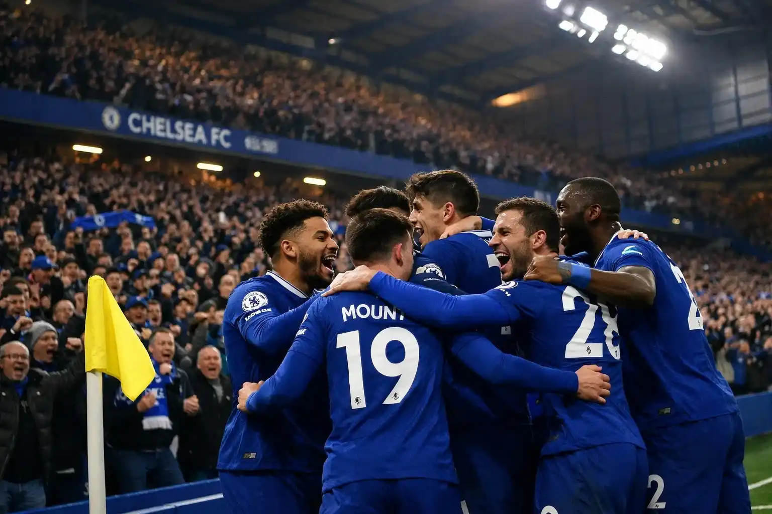 Chelsea players celebrating a goal in front of the home supporters at Stamford Bridge