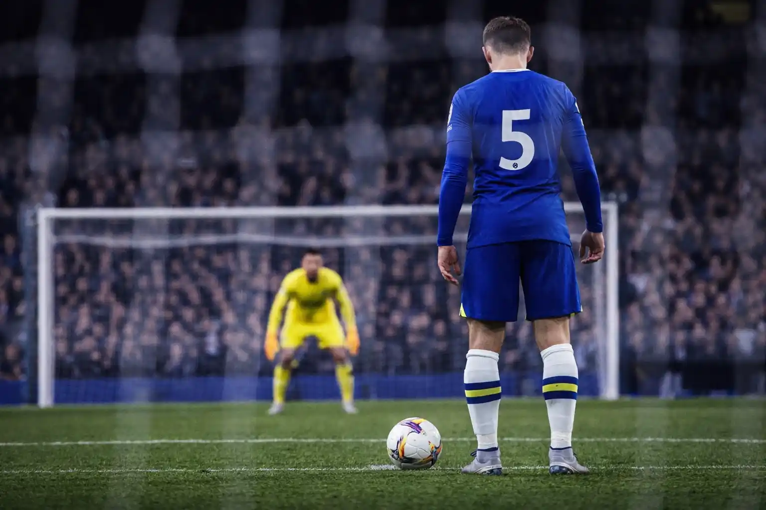 Football player preparing to take a penalty kick from the spot