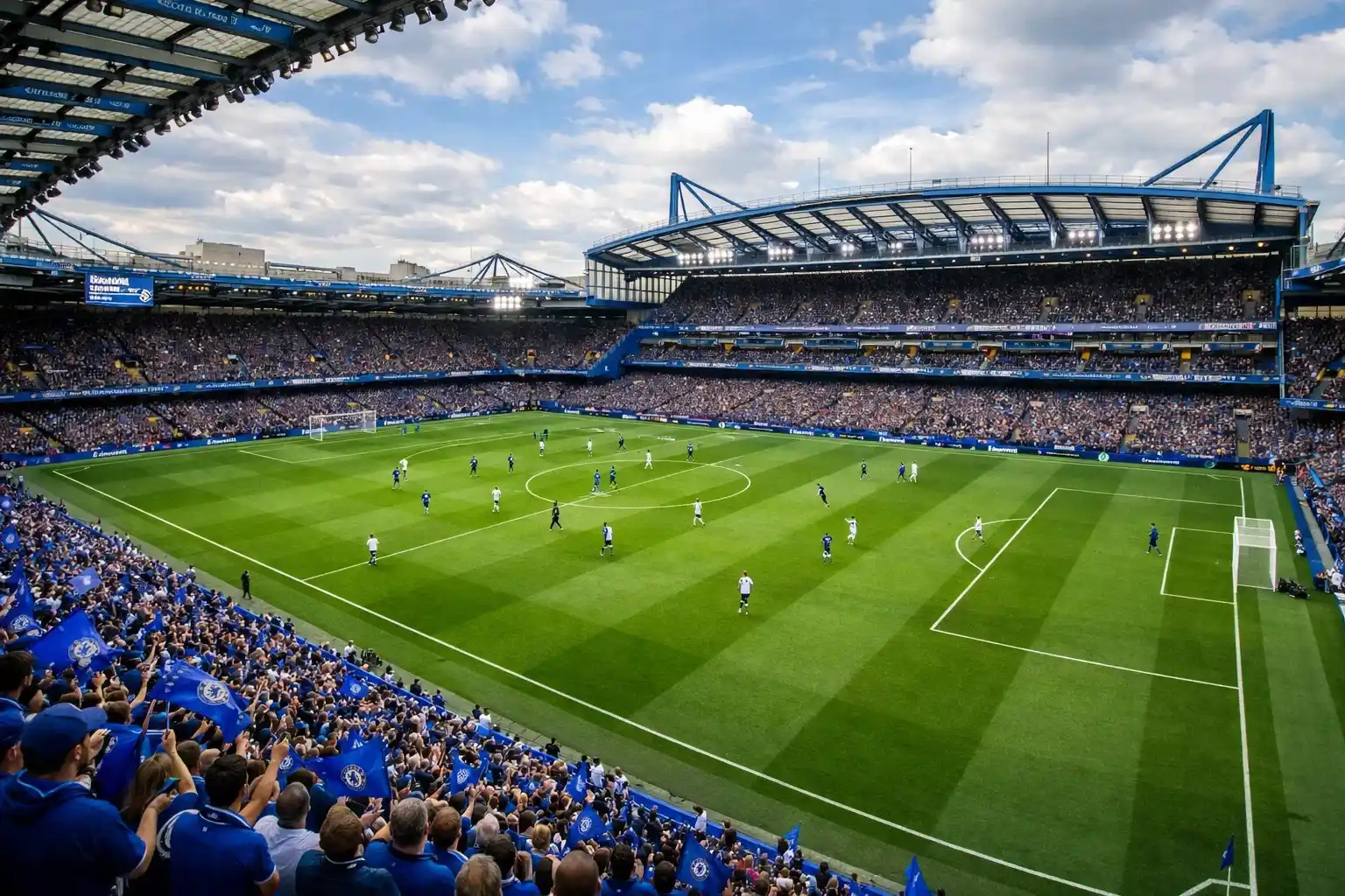Wide view of Stamford Bridge stadium during an afternoon Premier League match with fans in the stands